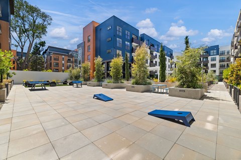 A courtyard with a blue bench and a blue object on the ground.