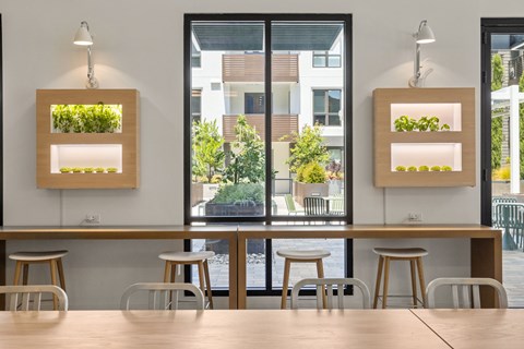 A modern dining area with wooden tables and chairs.
