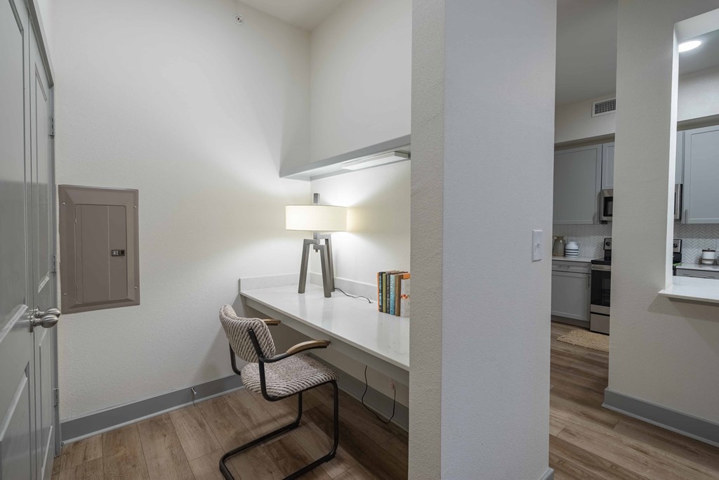 a bedroom with a desk and chair