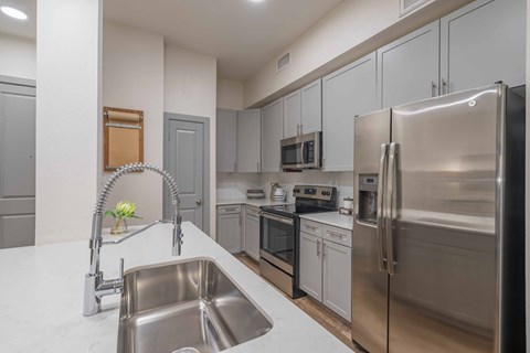 a kitchen with stainless steel appliances and a sink