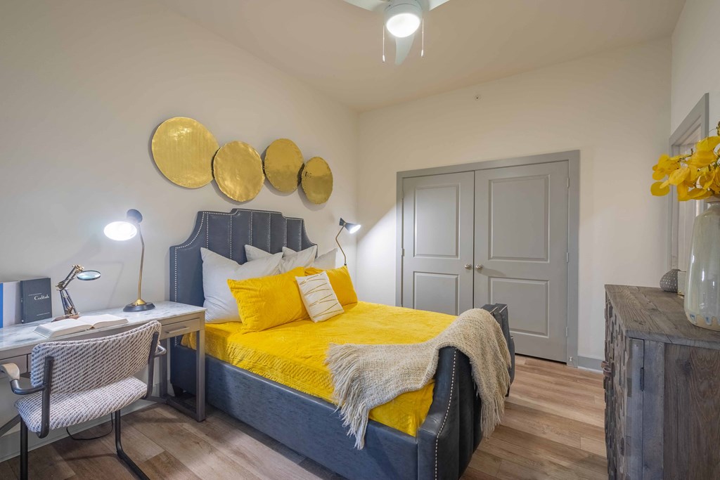 a bedroom with a bed and a desk