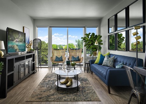 A living room with a blue couch and a coffee table.