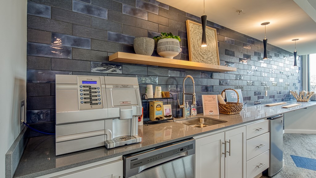 A modern kitchen with a microwave, oven, and sink.