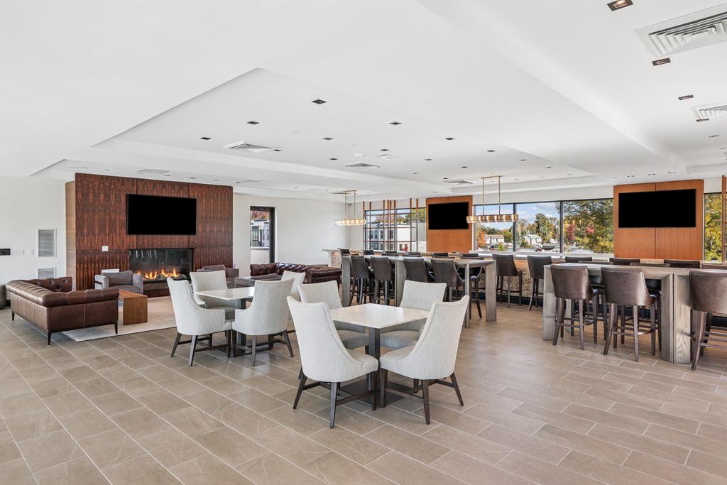 A modern living room with a fireplace and a dining area.