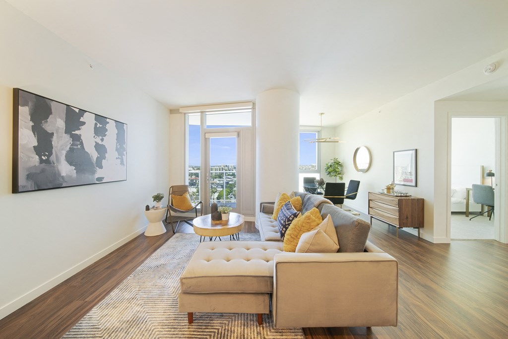 a living room with white walls and hardwood floors