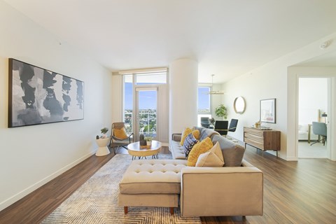 a living room with white walls and hardwood floors