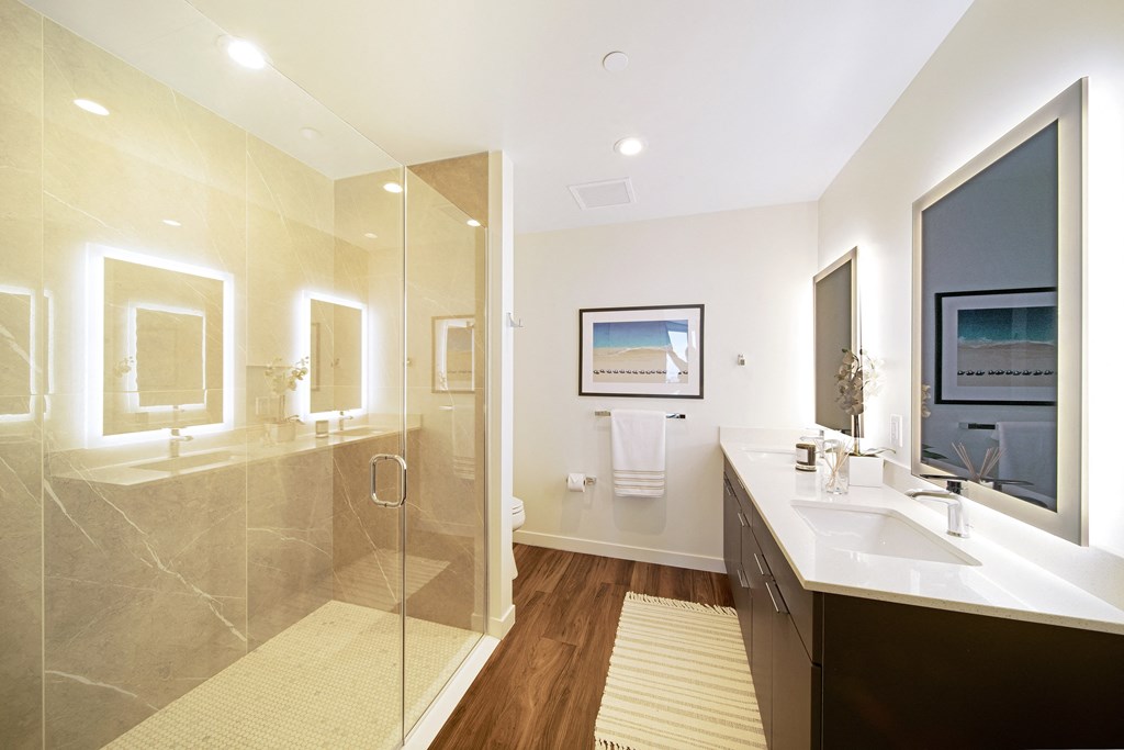 a bathroom with a glass shower stall