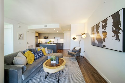 a living room with white walls and hardwood floors