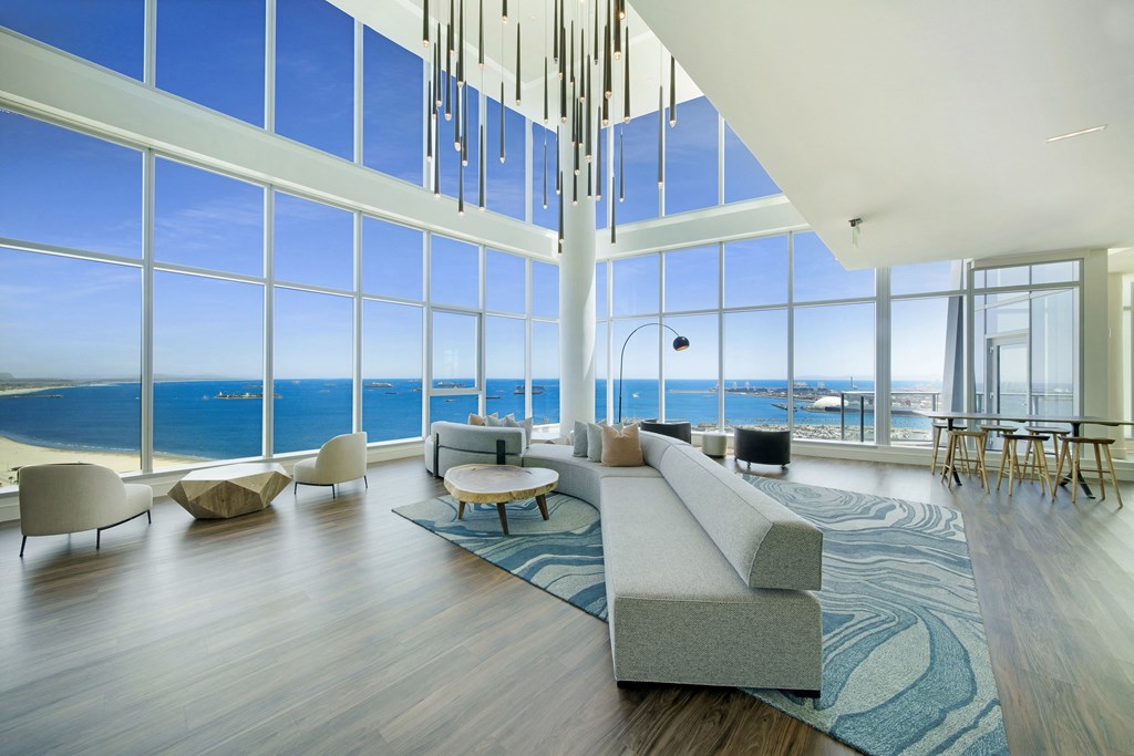 a living room with a large window and a view of the ocean