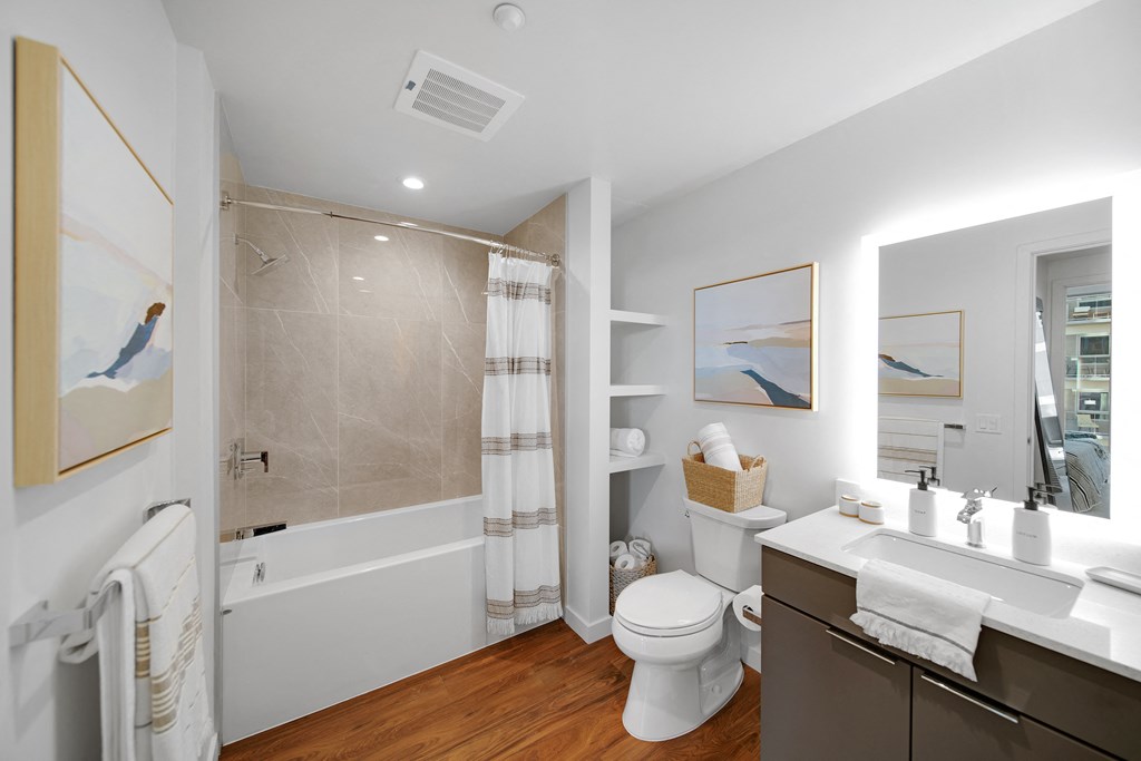 a bathroom with a toilet sink and bathtub in a 555 waverly unit