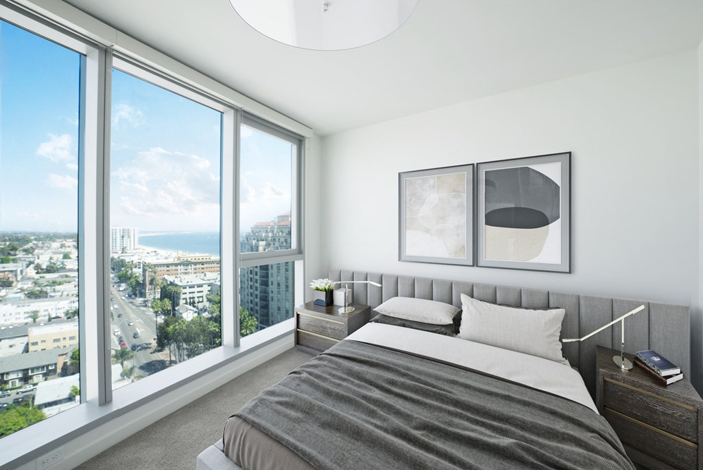 a bedroom with a large bed and a large window
