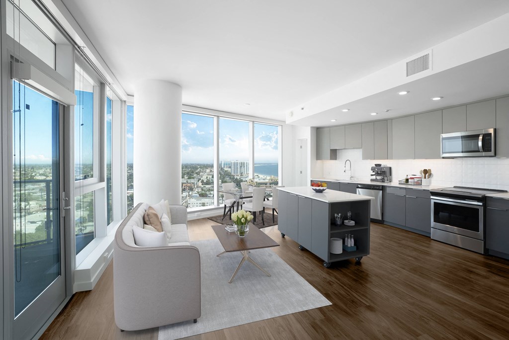 a living room filled with furniture and a large window