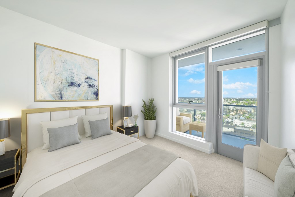 a bedroom with a large bed and a large window