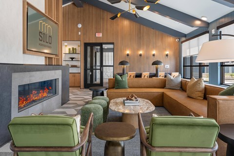 A modern living room with a fireplace and comfortable seating.