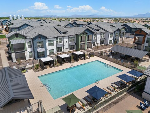 A swimming pool surrounded by apartment buildings.
