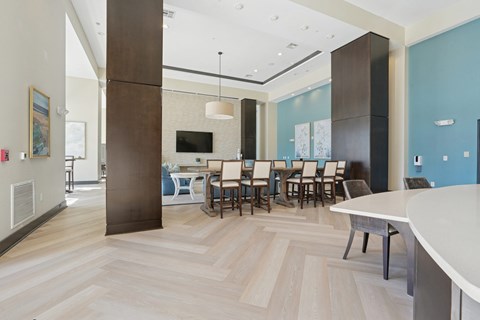 A modern dining room with a white table and chairs.