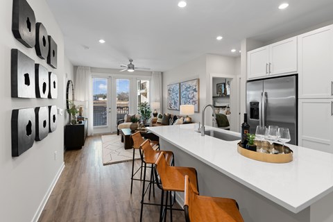 A modern kitchen with a dining table and chairs.