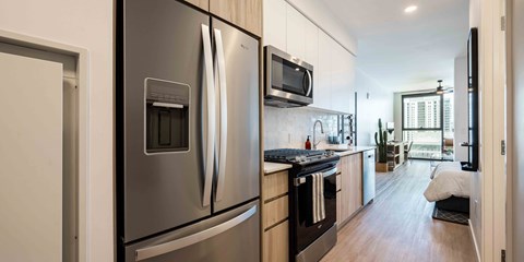 a kitchen with a refrigerator freezer and a stove top oven
