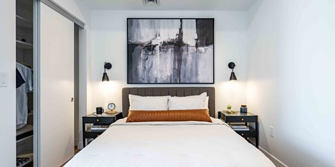 a bedroom with a large bed and two nightstands