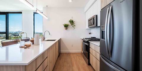 a kitchen with white countertops and wooden cabinets