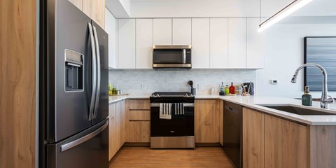 a kitchen with white cabinets and black appliances