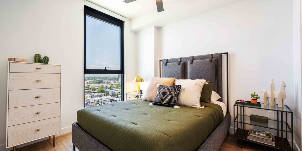 a bedroom with a large bed and a window