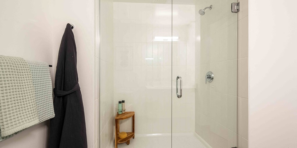 a bathroom with a shower and a towel rack