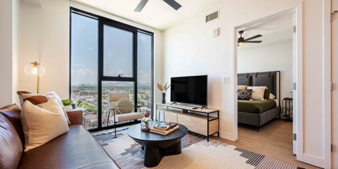 a living room with a large window and a couch