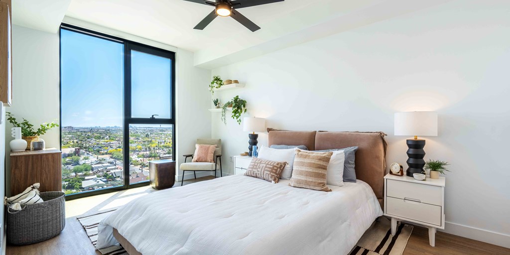 a bedroom with a large bed and a large window