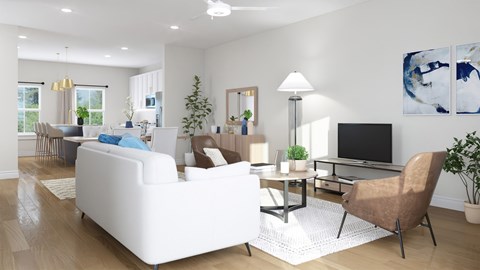 A modern living room with a white sofa, a brown chair, and a television.