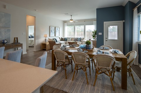 A dining room with a table set for six.
