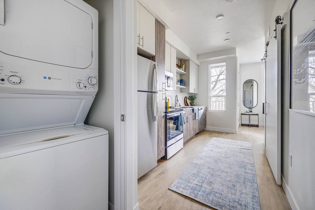 In-unit washer and dryer next to a kitchen area