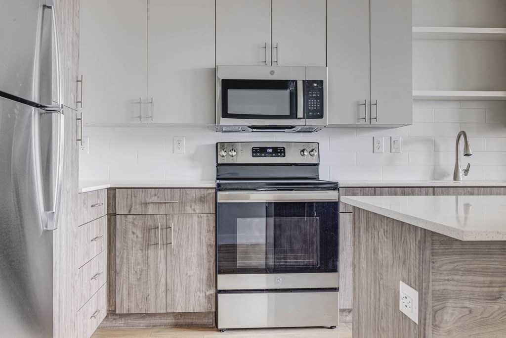 a kitchen with white cabinets and stainless steel appliances
