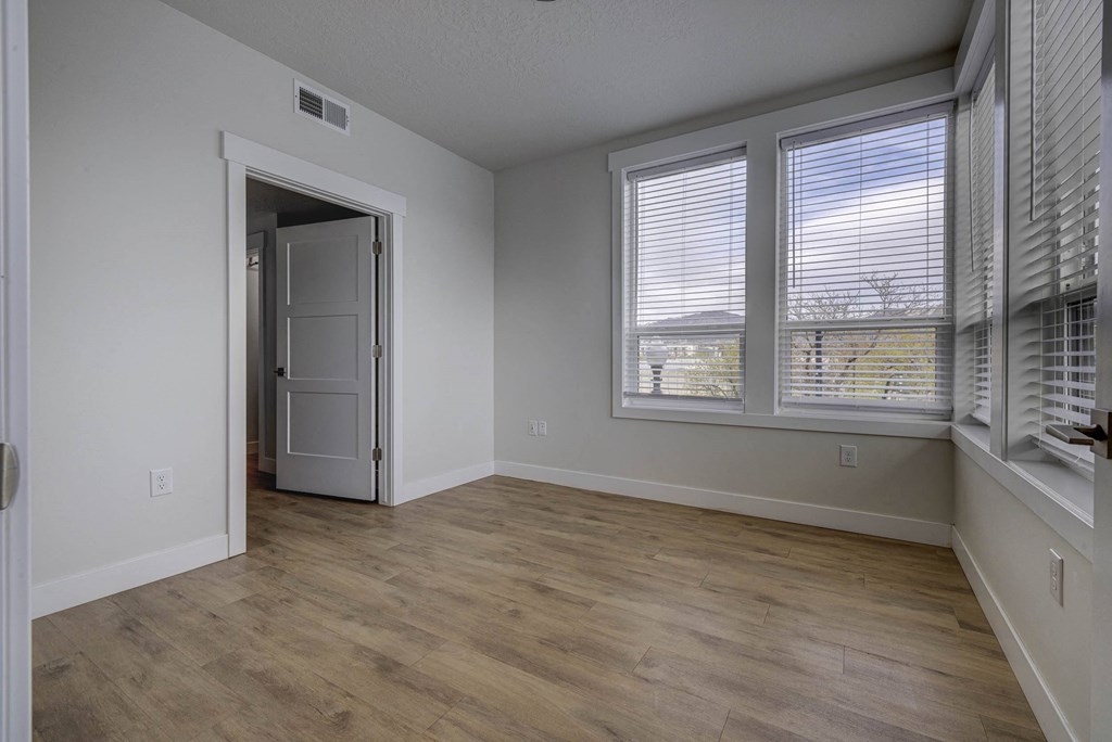 Empty bedroom space with windows
