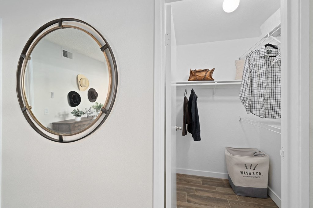 a mirror hanging on a wall next to a closet