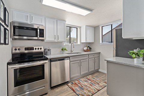 a kitchen with stainless steel appliances and white cabinets