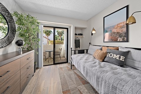 a bedroom with a bed and a sliding glass door to a patio