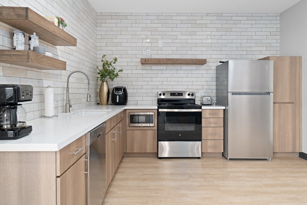 a modern kitchen with stainless steel appliances and wooden cabinets