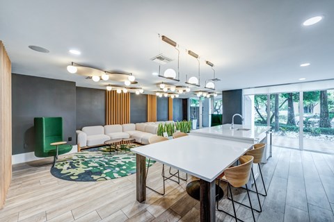 A modern dining room with a white table and chairs.