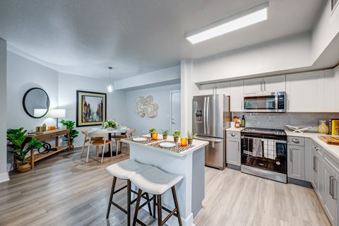 A modern kitchen with a dining table and chairs.