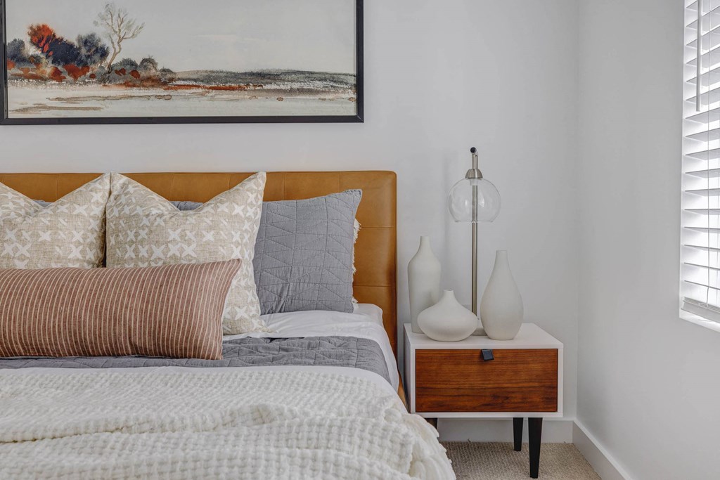 a bedroom with a bed and a nightstand