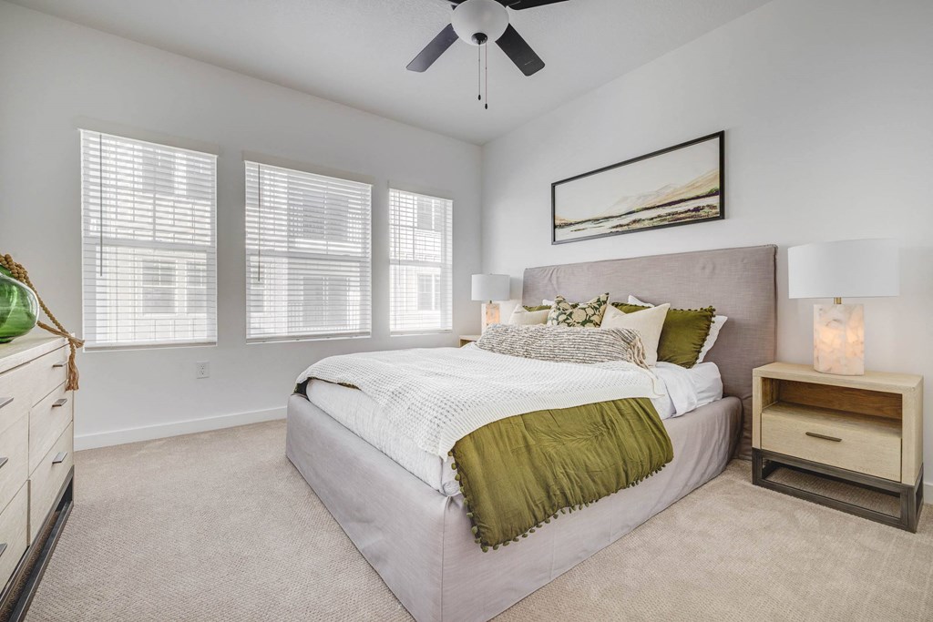 a bedroom with a bed and a ceiling fan