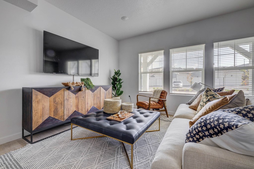 a living room with a couch and a coffee table in front of a tv