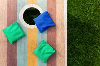 a striped table with blue and green napkins and grass
