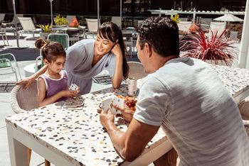 a family sitting at a table eating food