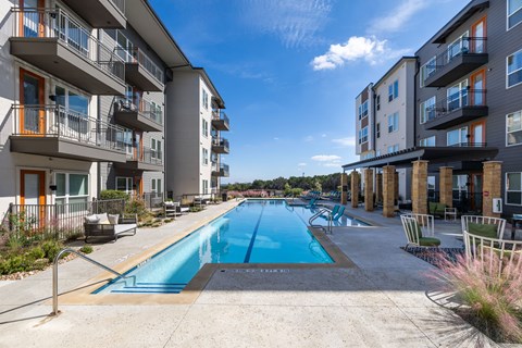 an apartment building with a swimming pool in the middle of it