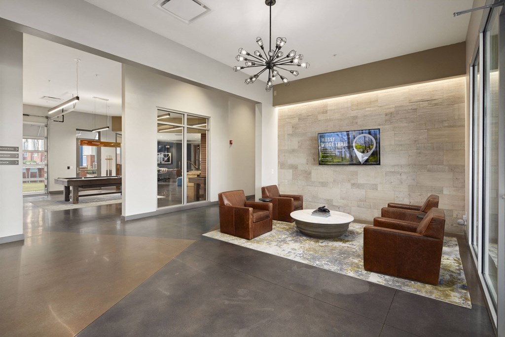 a lobby with couches and chairs and a table