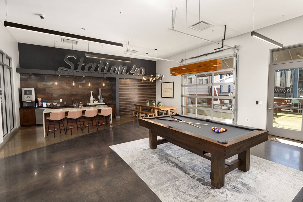 a game room with a pool table and a bar