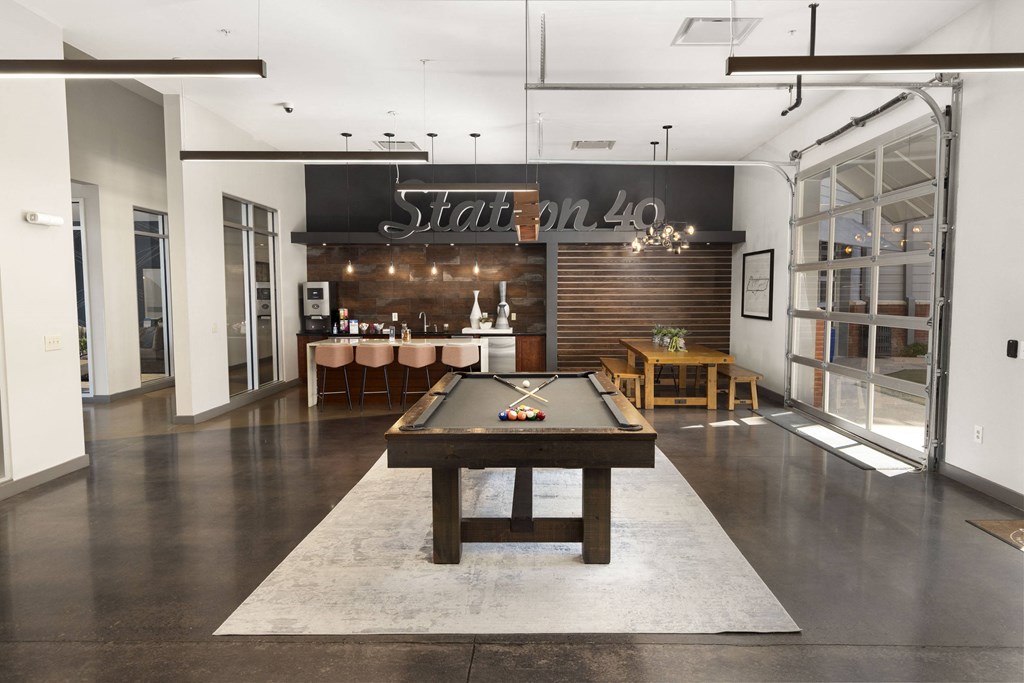 a game room with a pool table and a bar