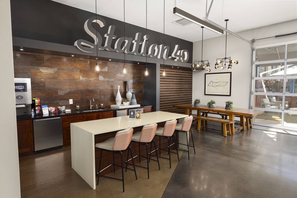 a dining room with a long table and chairs in front of a wall with a